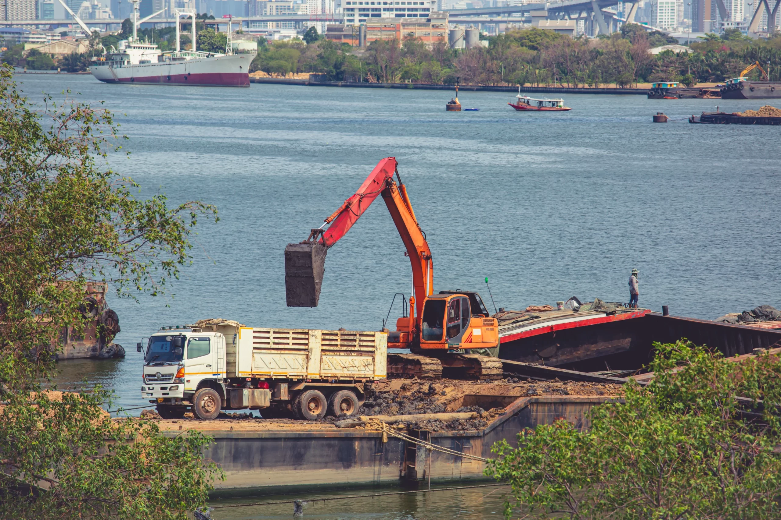 the-yellow-backhoe-is-working-at-the-river-floating-pier-to-clear-the-mud-of-sand-load-the-bucket-to-the-truck