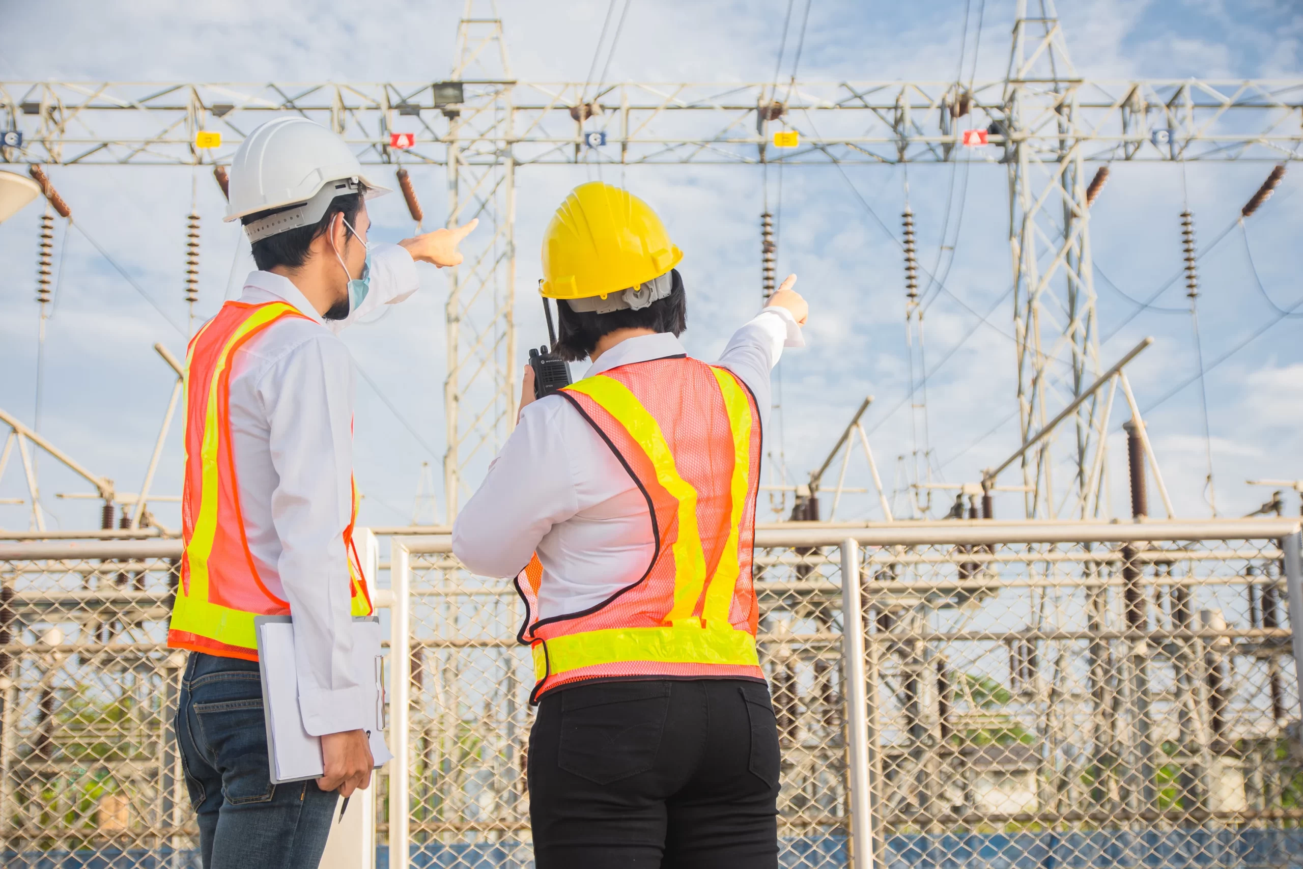 man-and-women-engineering-standing-communication-at-power-plant-electrical-system
